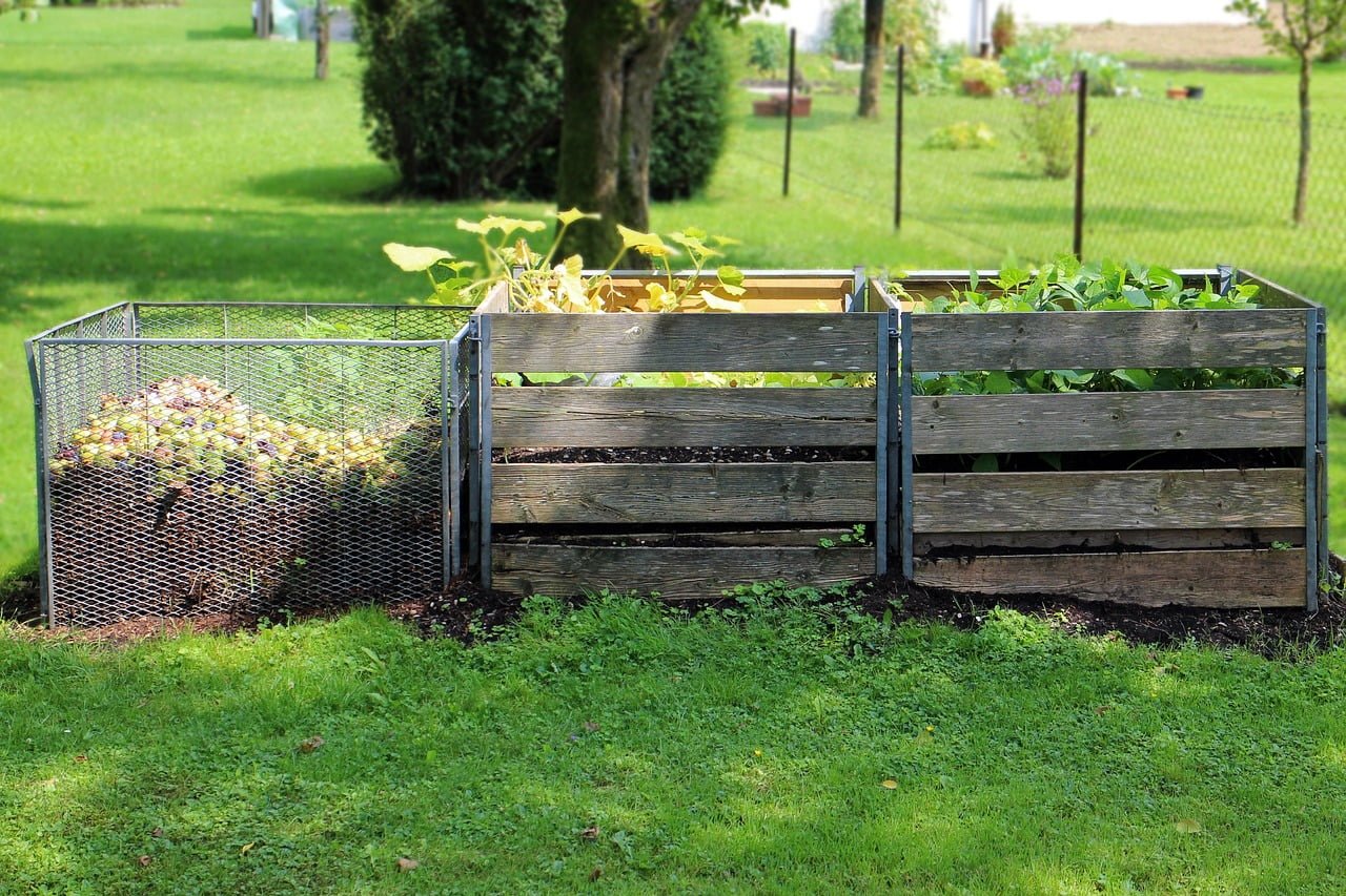 Farmers in Northeast India creating a compost pile using organic farm waste to improve soil health.