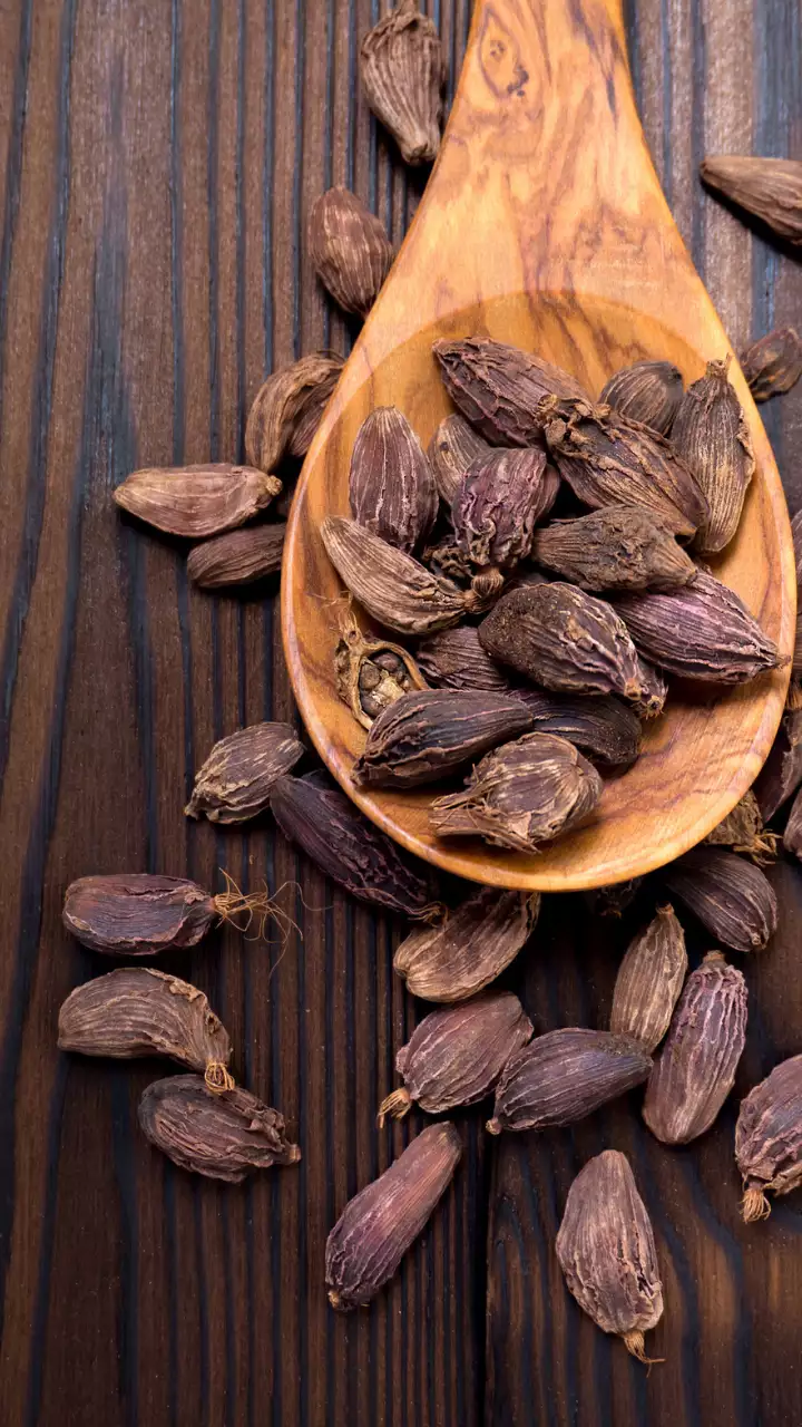 Close-up of large cardamom pods, also known as Badi Elaichi, showcasing their rich, smoky texture.
