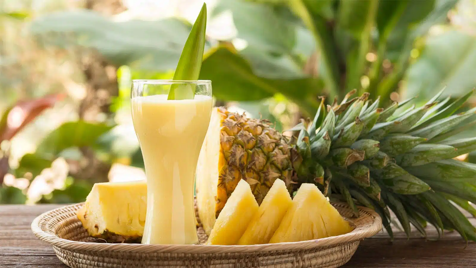A refreshing glass of Queen Pineapple juice served with a slice of the fruit.